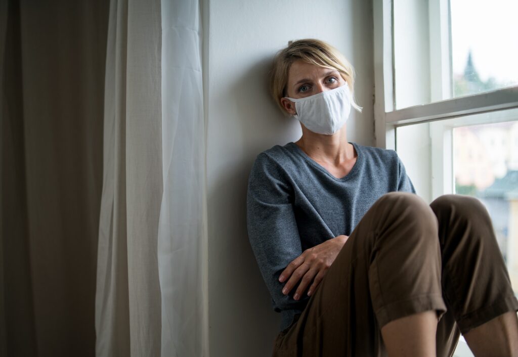 woman indoors at home feeling stressed mental health and coronavirus concept